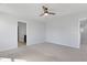 This bedroom features plush carpet, neutral paint, a ceiling fan, and access to an ensuite bathroom at 2105 Attend Xing, Fuquay Varina, NC 27526