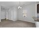 Bright dining area featuring a modern chandelier, neutral walls, and a view of the stairs to the second level at 2105 Attend Xing, Fuquay Varina, NC 27526