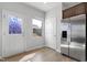 Eat-in kitchen with stainless steel refrigerator, wood floors, and a stylish door to the backyard at 2105 Attend Xing, Fuquay Varina, NC 27526