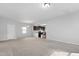 Spacious living room with plush carpeting and an open floor plan leading to the kitchen at 2105 Attend Xing, Fuquay Varina, NC 27526