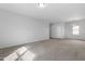 Spacious, carpeted living area with an open concept and staircase at 2105 Attend Xing, Fuquay Varina, NC 27526