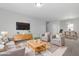 Staged living room featuring neutral tones, plush seating, and modern decor at 2105 Attend Xing, Fuquay Varina, NC 27526