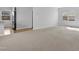 Spacious, carpeted living area with an open concept, showcasing natural light and ample space at 2105 Attend Xing, Fuquay Varina, NC 27526