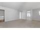 Spacious loft area featuring neutral carpet, light gray walls, and a laundry area to the left at 2105 Attend Xing, Fuquay Varina, NC 27526