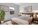 Staged primary bedroom featuring a wood bed frame, end tables with lamps, and neutral decor at 2105 Attend Xing, Fuquay Varina, NC 27526