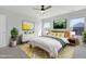Staged primary bedroom features neutral colors, with art and lamps on either side of the bed at 2105 Attend Xing, Fuquay Varina, NC 27526