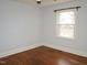 Cozy bedroom featuring hardwood floors, neutral paint, and ample natural light at 215 Sallinger St, Knightdale, NC 27545
