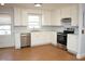 Bright kitchen featuring stainless steel appliances, white cabinetry, and tile floors at 215 Sallinger St, Knightdale, NC 27545