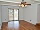 Spacious living room featuring hardwood floors, sliding glass doors, and neutral walls at 215 Sallinger St, Knightdale, NC 27545