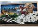 Welcome to Knightdale mural featuring cardinals, white flowers, and railroad tracks on a commercial brick building at 215 Sallinger St, Knightdale, NC 27545