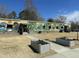 Exterior view of a school building featuring murals and planters on a sunny day at 215 Sallinger St, Knightdale, NC 27545
