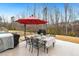 Outdoor patio area with dining set, grill, and mature trees, perfect for entertaining at 244 W Copenhaver Dr, Clayton, NC 27527