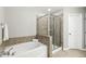 Bright bathroom with a glass-enclosed shower and separate soaking tub at 244 W Copenhaver Dr, Clayton, NC 27527