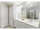 Bathroom features dual sinks with white cabinets and a large mirror above at 244 W Copenhaver Dr, Clayton, NC 27527