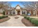 Community clubhouse featuring a welcoming entrance, manicured landscaping, and a charming facade at 244 W Copenhaver Dr, Clayton, NC 27527