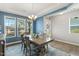 Bright dining room with blue walls, chandelier, and a large window overlooking the yard at 244 W Copenhaver Dr, Clayton, NC 27527