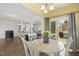 Charming dining area with white table, ample light, and view into the living room at 244 W Copenhaver Dr, Clayton, NC 27527