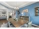 Bright dining room with modern furniture, lighting, and access to the living room at 244 W Copenhaver Dr, Clayton, NC 27527