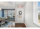 Bright entryway featuring a white door, view into the dining area, and large windows at 244 W Copenhaver Dr, Clayton, NC 27527