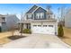 Charming two-story home with a well-manicured lawn and a two-car garage, offering curb appeal at 244 W Copenhaver Dr, Clayton, NC 27527
