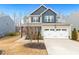 Charming two-story home featuring a two-car garage, covered porch, and well-maintained landscaping at 244 W Copenhaver Dr, Clayton, NC 27527