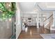 Open foyer with hardwood floors, staircase, and a seamless transition to the living area at 244 W Copenhaver Dr, Clayton, NC 27527