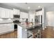 Stylish kitchen featuring white cabinets, granite counters, stainless appliances, and island seating at 244 W Copenhaver Dr, Clayton, NC 27527
