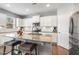 Modern kitchen with granite countertops, stainless steel appliances, and white cabinetry at 244 W Copenhaver Dr, Clayton, NC 27527