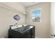 Laundry room with modern washer and dryer, storage shelf, and window at 244 W Copenhaver Dr, Clayton, NC 27527