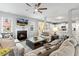 Cozy living room featuring fireplace, comfortable sofas, and a view of the kitchen at 244 W Copenhaver Dr, Clayton, NC 27527