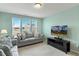 Inviting living room with large windows, comfortable seating, and modern entertainment center at 244 W Copenhaver Dr, Clayton, NC 27527