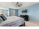 Main bedroom boasts a ceiling fan, large windows, and TV mounted on the wall at 244 W Copenhaver Dr, Clayton, NC 27527