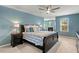 Bright main bedroom with a ceiling fan, en-suite sitting area with fireplace, and large windows at 244 W Copenhaver Dr, Clayton, NC 27527