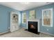 En-suite sitting area with a cozy fireplace and built-in shelving at 244 W Copenhaver Dr, Clayton, NC 27527