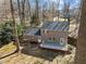 Aerial view showcasing home exterior with a back deck and a spacious, tree-filled yard at 306 Northcliff Dr, Durham, NC 27712