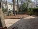 Stone backyard with grass and trees at 3109 Benton Cir, Raleigh, NC 27615