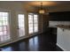 Sunlit dining area with dark hardwood floors, a modern light fixture, and kitchen access at 3109 Benton Cir, Raleigh, NC 27615
