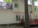 Beige two-story home with red deck and white trim, nestled beneath shady trees at 3109 Benton Cir, Raleigh, NC 27615