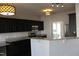 Bright kitchen with black cabinets, granite countertops, stainless appliances, and modern pendant lighting at 3109 Benton Cir, Raleigh, NC 27615