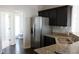 Modern kitchen featuring granite countertops, stainless steel appliances, and dark cabinets at 3109 Benton Cir, Raleigh, NC 27615