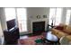 Cozy living room with a fireplace, large windows, and comfortable seating at 3109 Benton Cir, Raleigh, NC 27615