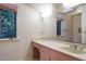 The bathroom is bright, with a large mirror, plenty of counter space, and a window to the outside at 3601 Swann St, Raleigh, NC 27612
