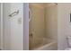 This bathroom is clean and orderly, with a standard bathtub, a towel rack, and patterned wallpaper at 3601 Swann St, Raleigh, NC 27612