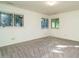 The bedroom is spacious, with multiple windows and neutral carpet for comfort and style at 3601 Swann St, Raleigh, NC 27612