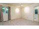 The bedroom has neutral carpet, a bright window, and an open entryway into another room at 3601 Swann St, Raleigh, NC 27612