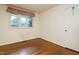 Bedroom with hardwood flooring, window with wood trim and natural light at 3601 Swann St, Raleigh, NC 27612