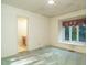 A bedroom featuring a bright window and an attached bathroom for added convenience at 3601 Swann St, Raleigh, NC 27612