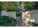 Inviting gated entrance of a home with lush landscaping and a stone pathway, creating a private and serene ambiance at 3601 Swann St, Raleigh, NC 27612