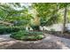 Landscaped garden featuring circular planting with gravel paths and a white perimeter wall at 3601 Swann St, Raleigh, NC 27612