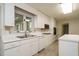 Bright kitchen features white cabinetry, laminate countertops, and stainless steel sink at 3601 Swann St, Raleigh, NC 27612